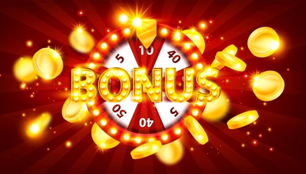 A vibrant casino-style bonus wheel with the word "BONUS" in illuminated letters. The wheel is surrounded by golden coins and has numbers like 5, 10, and 40 visible on its segments. The background is a deep red with radiating light beams.