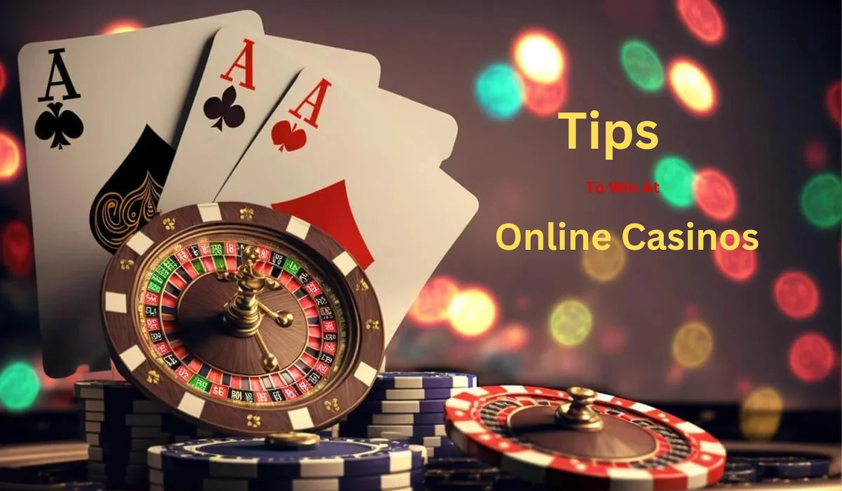 Casino game elements including three playing cards showing aces, a roulette wheel, and casino chips. Text overlay reads "Tips to win at Online Casinos" against a background of blurred colorful lights.